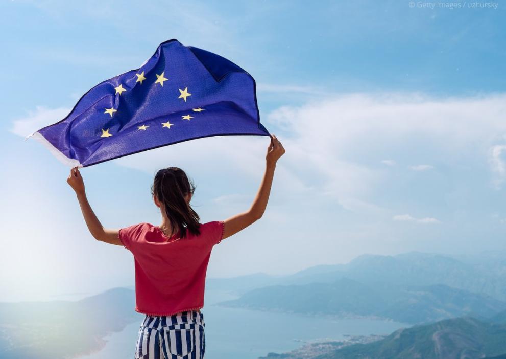 Person holding EU flag 